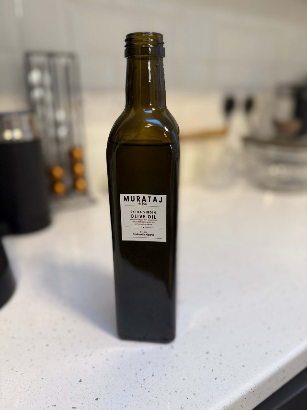 Murataj & Son Reserve extra virgin olive oil, 500ml green glass bottle on a kitchen counter
