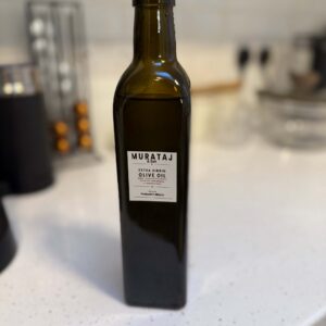 Murataj & Son Extra Virgin Olive Oil 500ml bottle on kitchen counter.